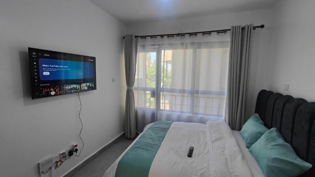 Μια τηλεόραση ή/και κέντρο ψυχαγωγίας στο Studio Apartment - The Arc II