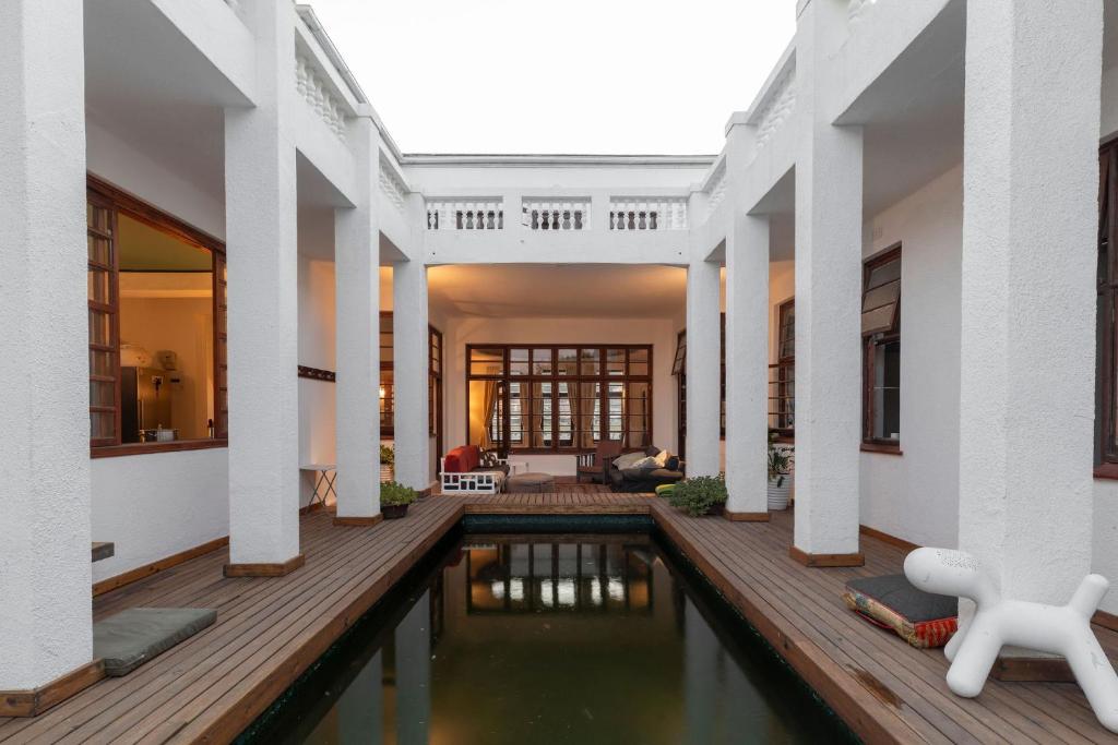 a pool in the middle of a house at Axminster House in Muizenberg