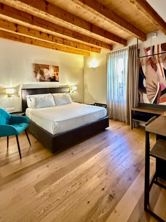 a bedroom with a large bed and a piano at Malvezzi24 Boutique Rooms in Desenzano del Garda
