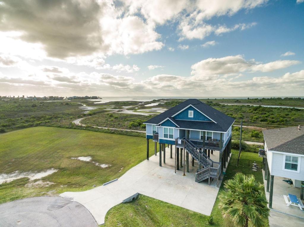 an overhead view of a blue house on a lawn at Sandy Hook in Galveston