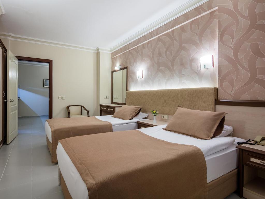 Ένα ή περισσότερα κρεβάτια σε δωμάτιο στο May Flower Apart Hotel