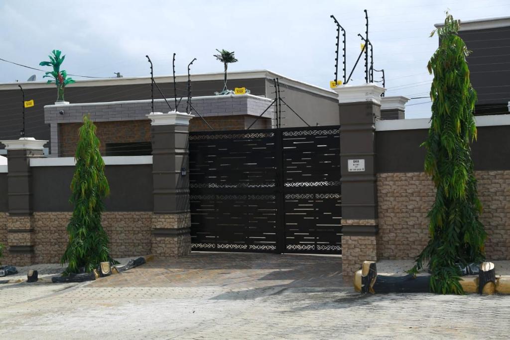 a building with two trees in front of it at Erliz villa in Kumasi