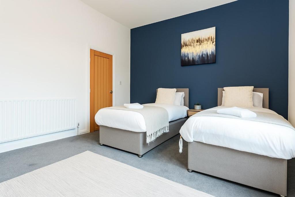 two beds sitting next to each other in a room at Herschell House - Central Location - Free Parking, Fast Wifi, SmartTV with Netflix - Perfect for Contractors, Families and Groups by Yoko Property in Redcar