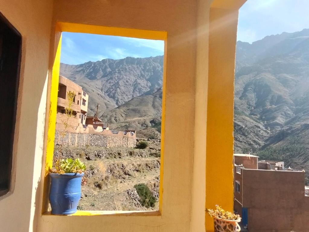 a window with a view of a mountain at riad atlas imnane in Imlil