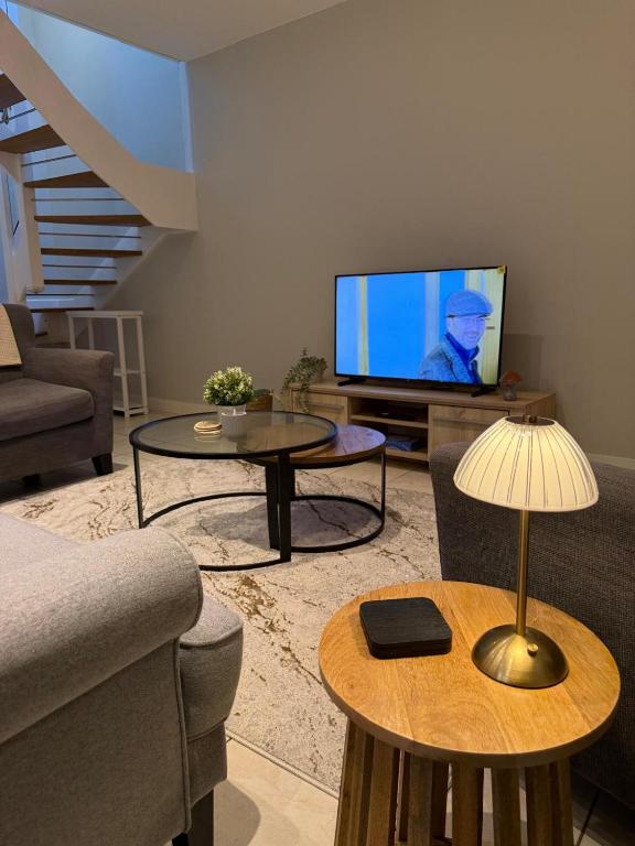 a living room with a couch and a tv at 4 School Path in Ironbridge