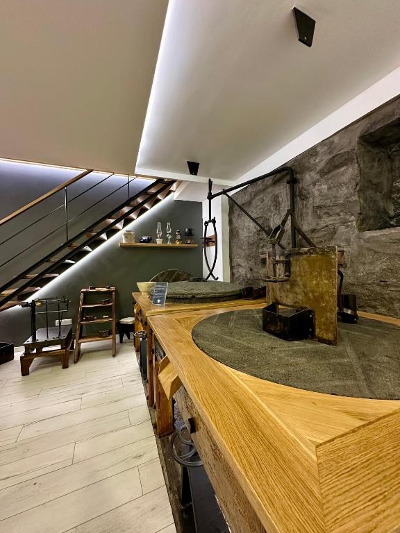a room with a stone wall and a wooden counter at The Mill House in Lagoa