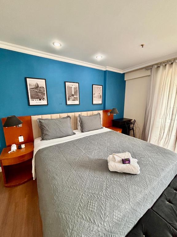 a bedroom with a large bed with a towel on it at Flat Barra Residence-4 pessoas-Fa1204-3 in Rio de Janeiro