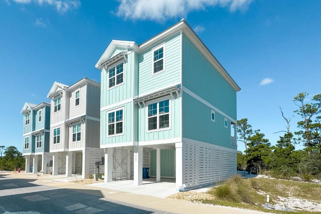 a large white and blue building on a street at Waves & Wildlife Getaway at Summer Salt in Orange Beach