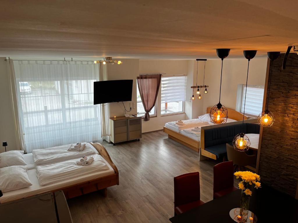 a hotel room with two beds and a television at Rohrbacher Herz in Rohrbach in Oberösterreich