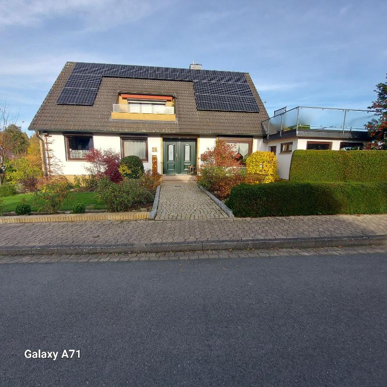 a house with solar panels on the roof at Ferienwohnung Flegessen Weserbergland in Bad Münder am Deister