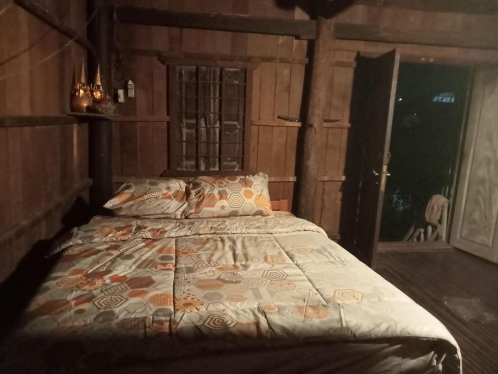 a bedroom with a bed in a room with a window at Sconvolt Homestay in Kratie