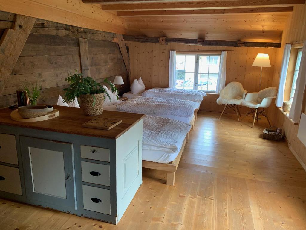 a bedroom with a bed and a desk in a room at Fischerhäuser Romanshorn in Romanshorn