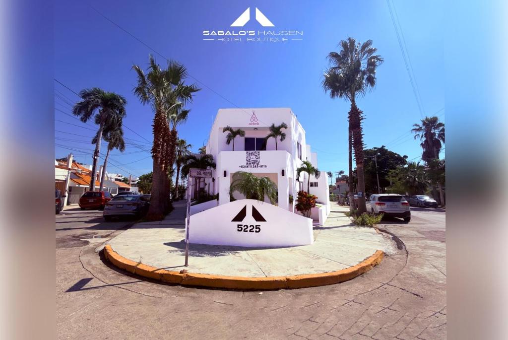 a building with a sign in the middle of a street at Sabalo's Hausen in Mazatlán