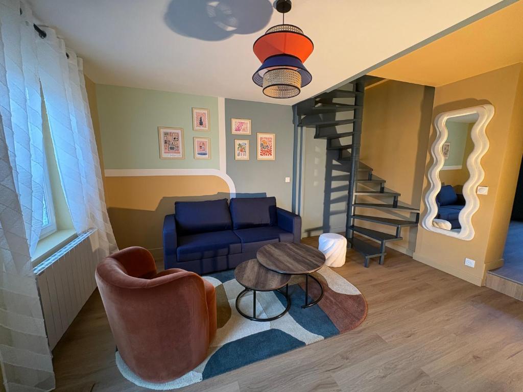 a living room with a couch and a stair case at Cozy House in Yvetot