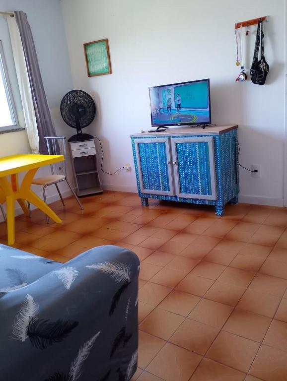 a living room with a tv sitting on a stand at Lar caprichoso in Aracaju