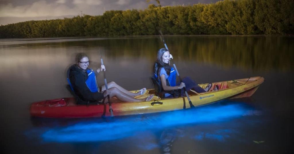 two people sitting in a kayak on the water at Island House #12 at Rum Point in Driftwood Village