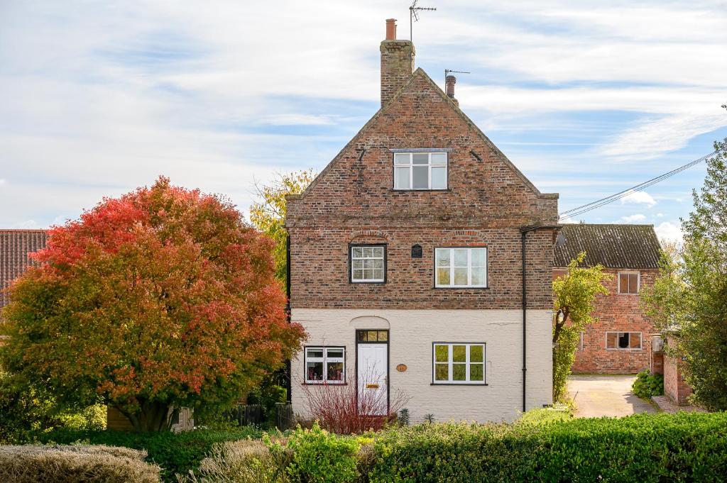 an old brick house with a roof at Historic Riverside House - Village, River Walks & Easy York Access in Cawood