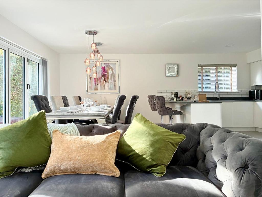 a living room with a couch and a dining room at Luxury 5 Bedroom House near York - Escrick in Escrick