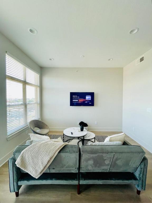 a living room with a couch and a table at Cozy, Charming, and Chic Stay in Dallas