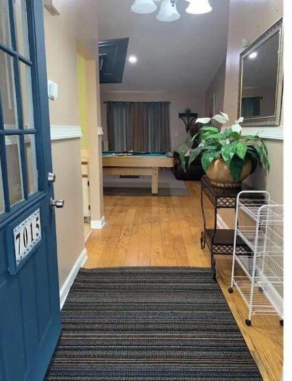a hallway with a door and a room with a couch at Ortona's Best Kept Secret Three-Two Spacious Home in Orlando