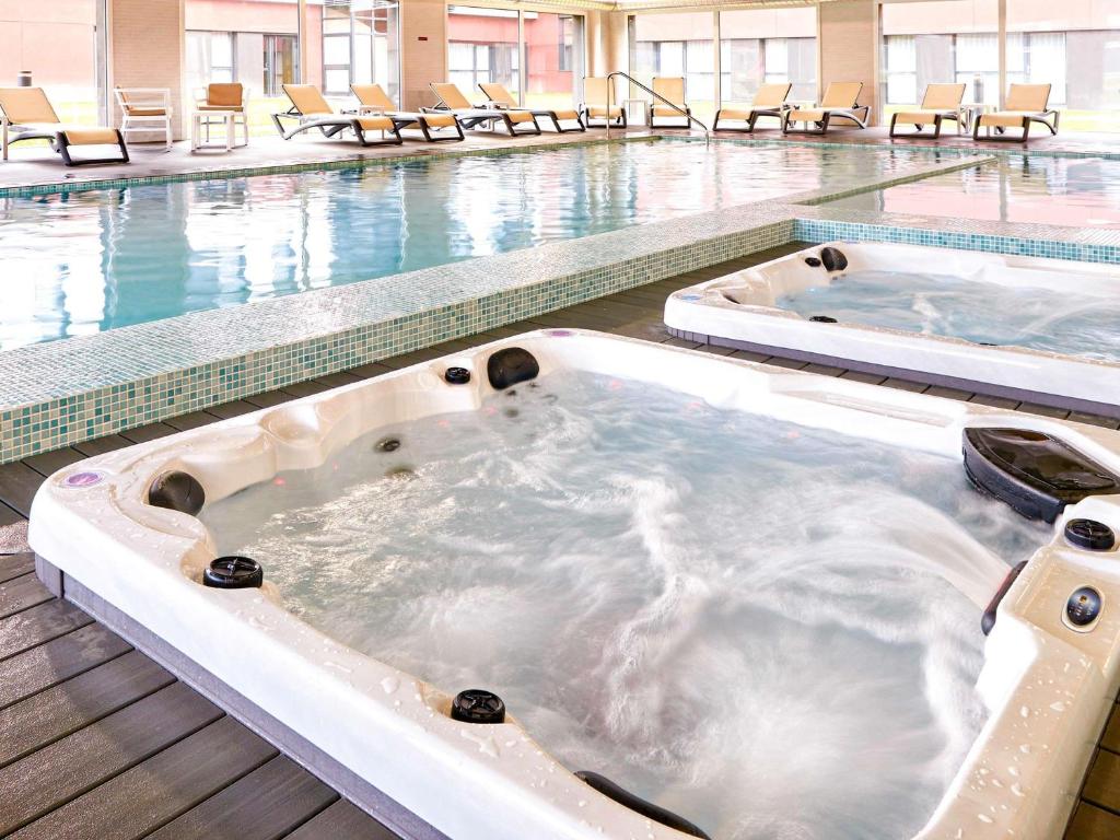 a jacuzzi tub in a swimming pool at Aparthotel & Spa Adagio Vannes in Vannes