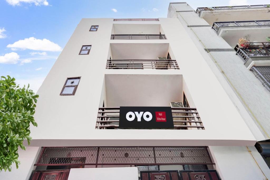 an apartment building with an ovo sign on it at Hotel O Royal residency in Dera Māndi