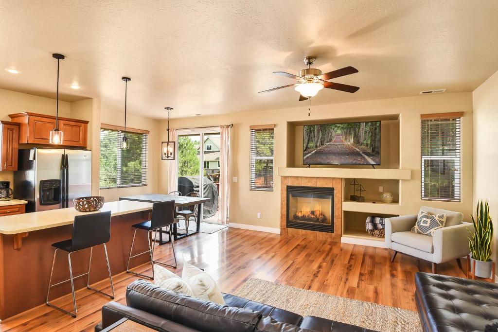 a kitchen and living room with a fireplace at Pine Mountain Trail Pool Table Dog Family Fun in Flagstaff in Flagstaff