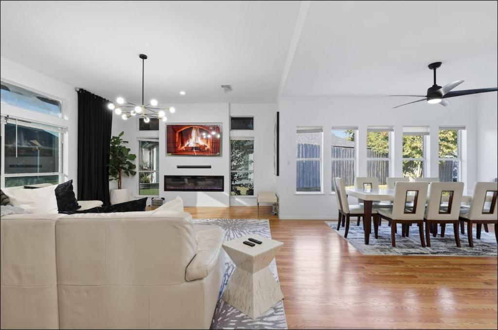a living room with a white couch and a table at Homes in Prosper in Prosper