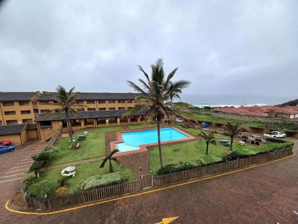 an aerial view of a resort with a swimming pool and palm trees at Andante Villas in Kingsburgh