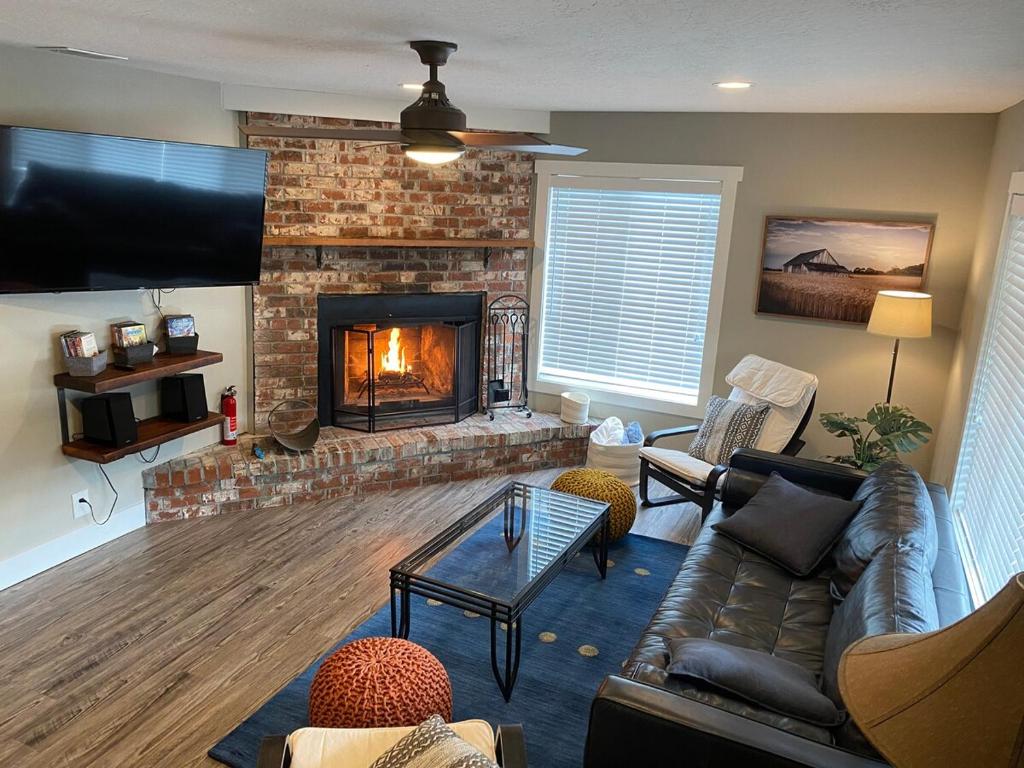 a living room with a fireplace and a couch at Mountain view, 5-bedroom home with sauna in Oakridge