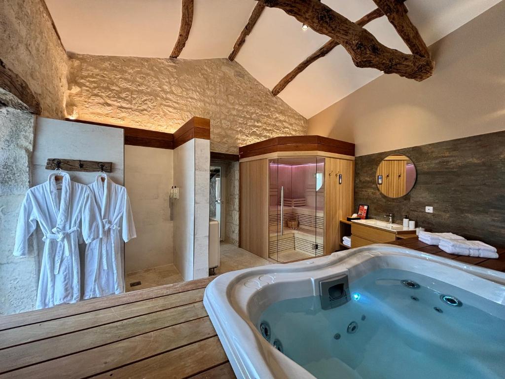 a bathroom with a large tub in a room at Domaine d Arcadie in Montaigu-de-Quercy