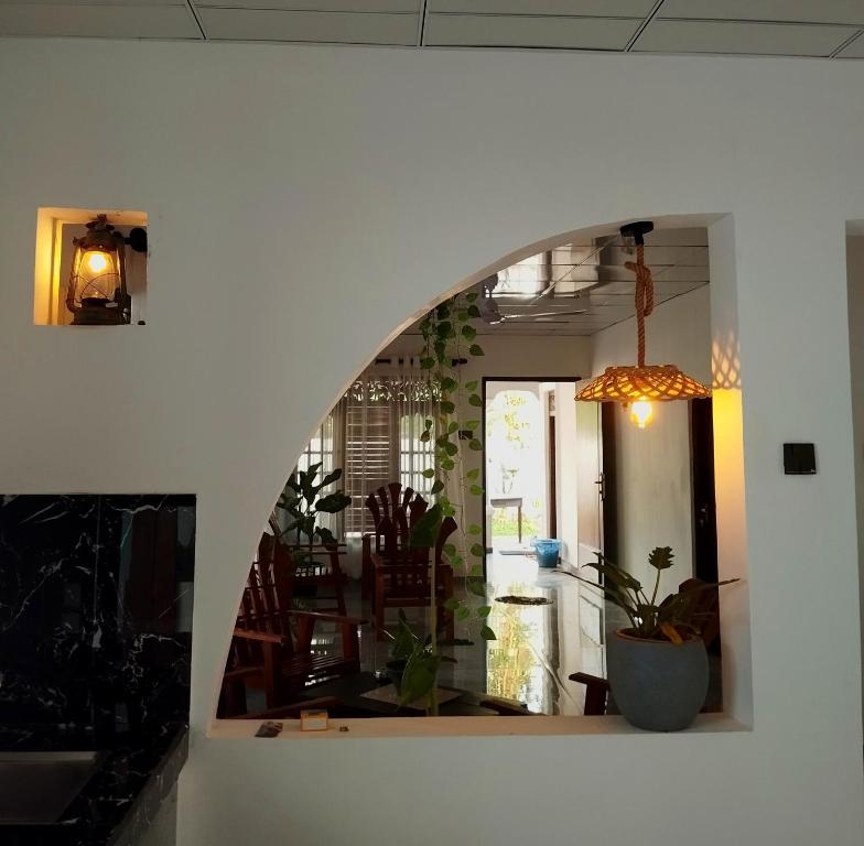 an archway in a living room with a potted plant at Junction 14 Villa in Dikwella North