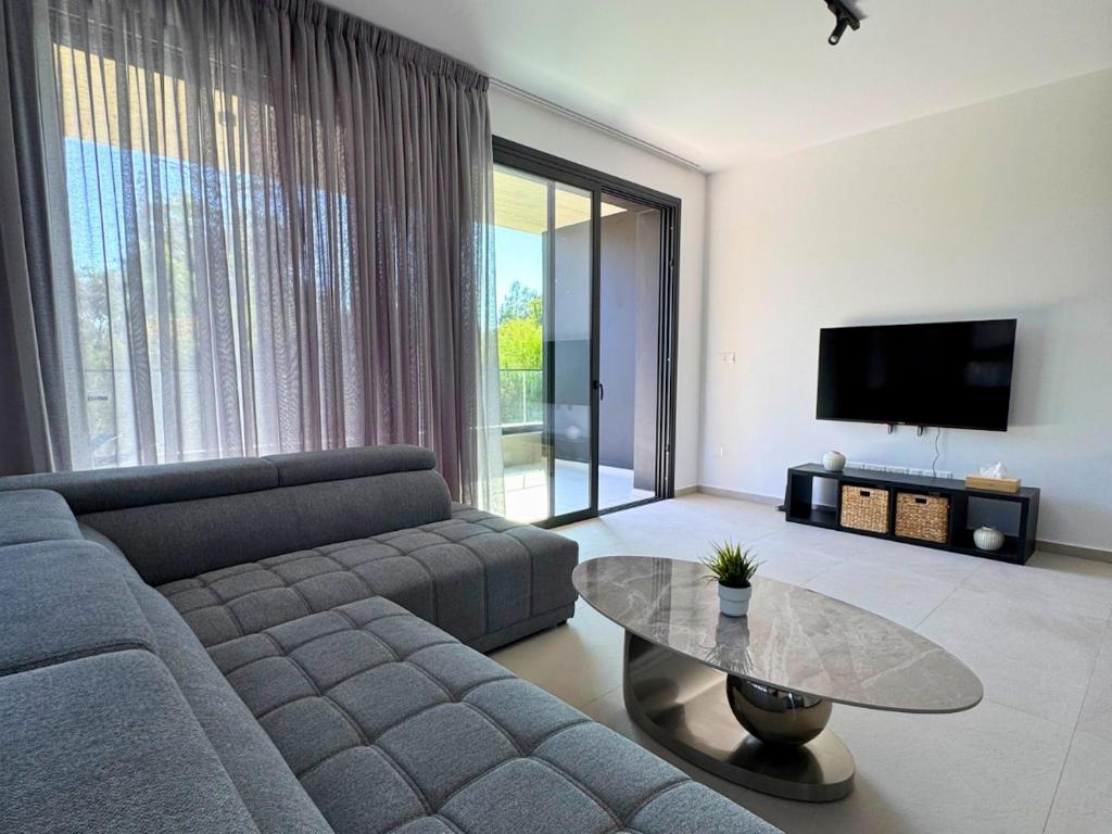 a living room with a couch and a table at Hypnos Park View in Nicosia