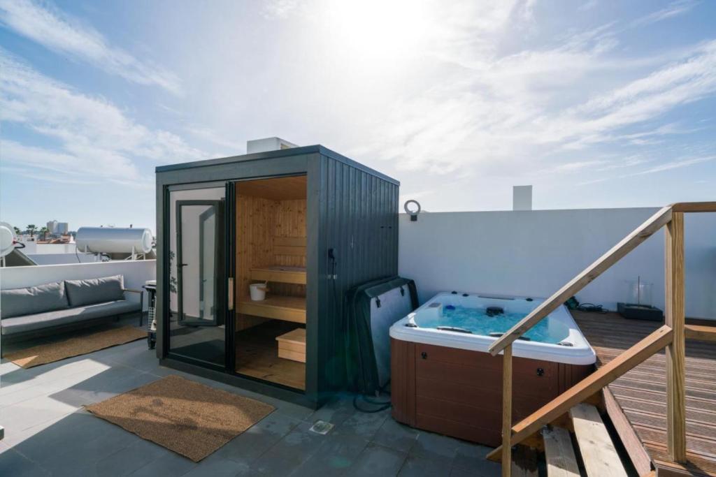 a hot tub on the roof of a house at Rooftop Alvor Apartment by Moje Holiday in Alvor