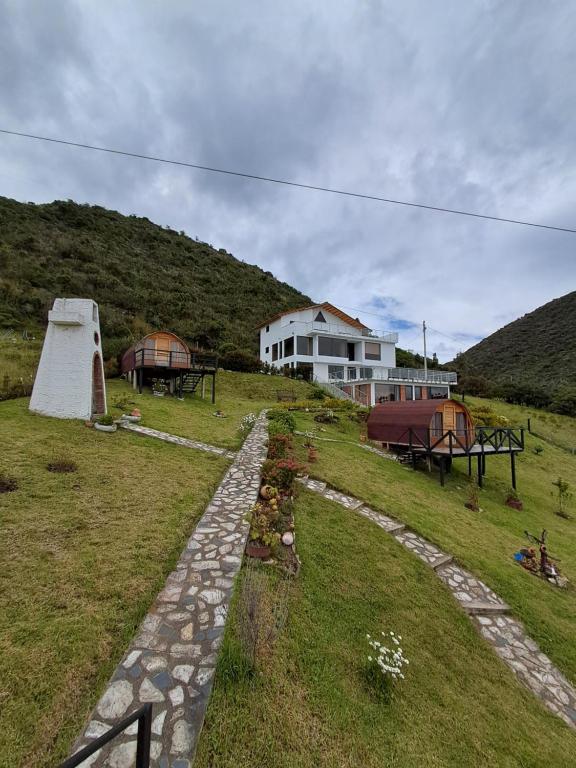 a house on top of a hill with a stone path at Suit Encanto Dorado in Guatavita