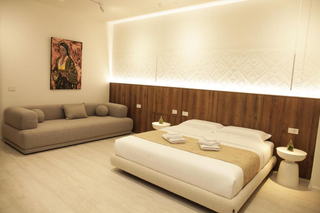 a bedroom with a large bed and a couch at A Gallery Hotel in Shkodër