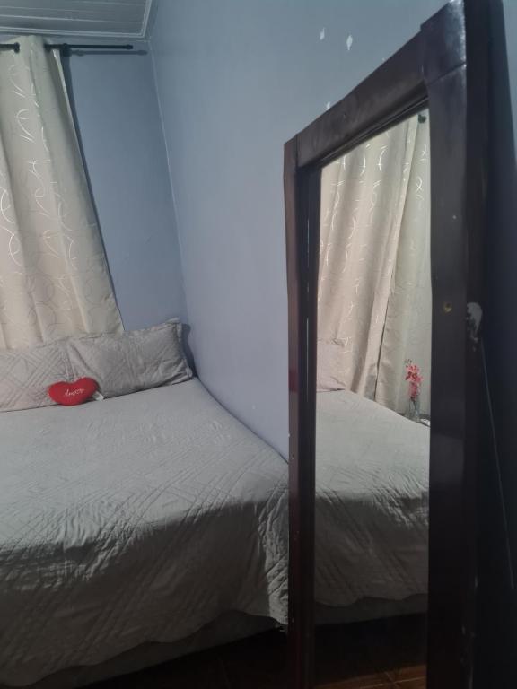a bedroom with a bed with a mirror on it at Pousada Pôr do Sol in Belém