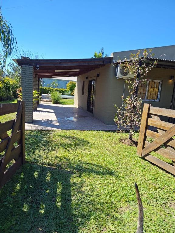 a fence in front of a house with a gate at Beautiful Quinta in Corrientes in Paso de la Patria