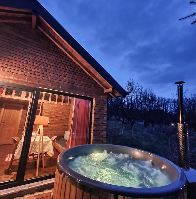 a hot tub on the deck of a house at Lura Agroturizem in Novoberdo