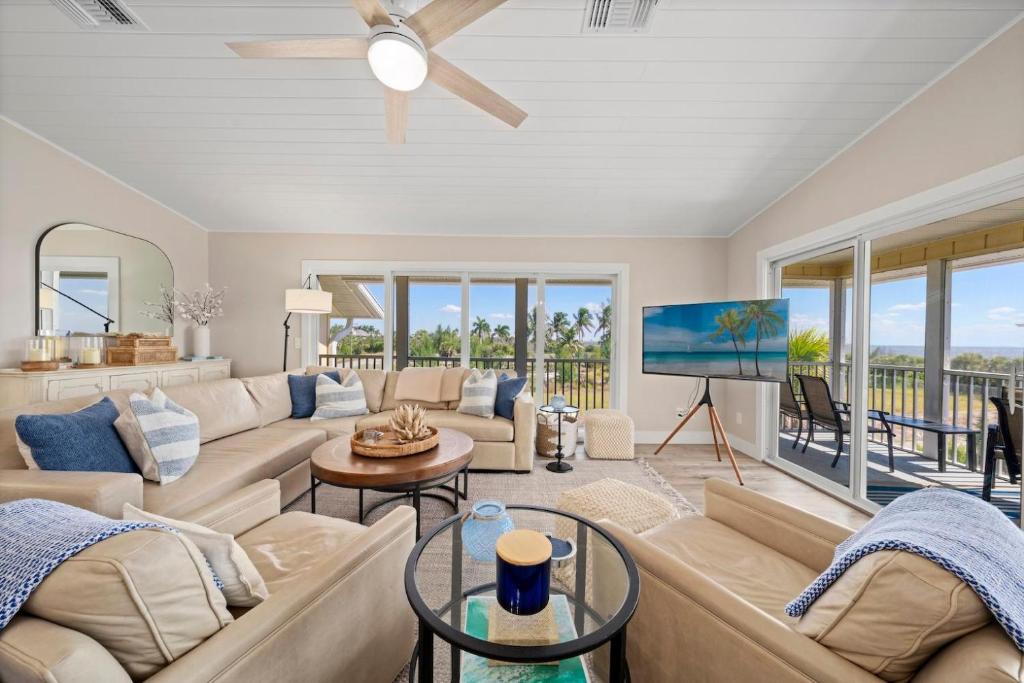 a living room with a couch and a tv at Surfside 12 A4 in Sanibel