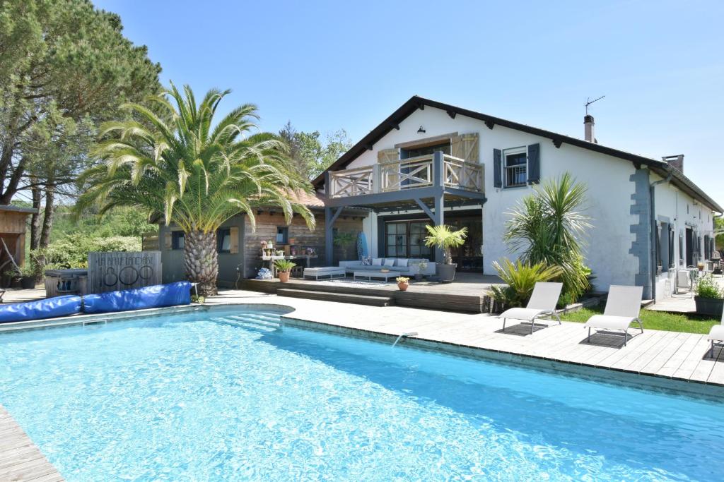 a house with a swimming pool in front of a house at La Belle Landaise 1809 studio 4 couchages in Peyrehorade