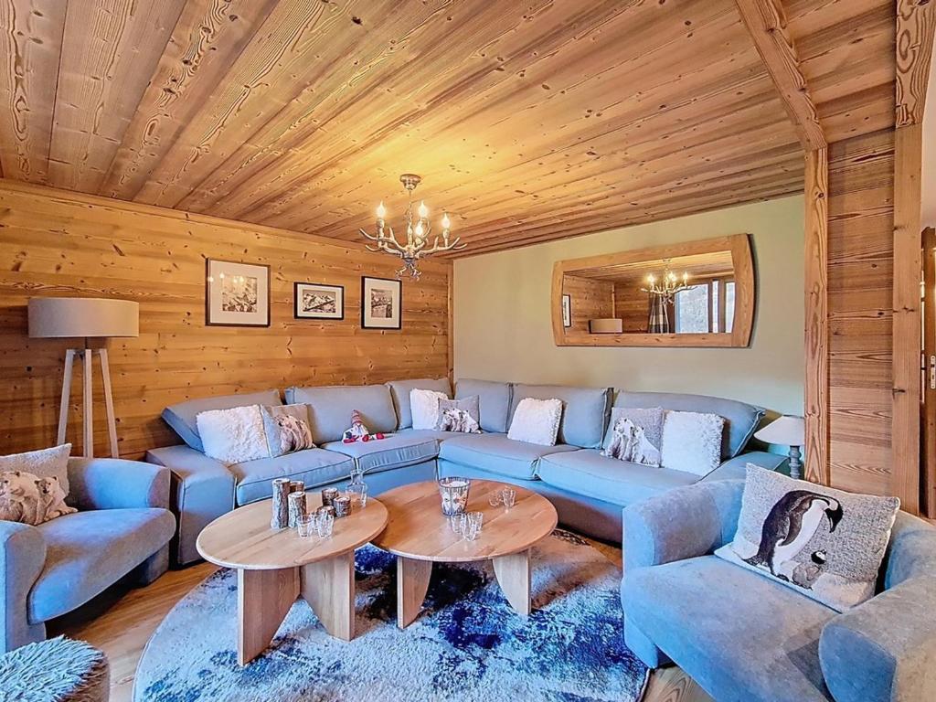 ein Wohnzimmer mit blauen Sofas und einem Tisch in der Unterkunft Appartement spacieux et confortable A proximité des pistes Balcon WIFI - FR-1-344-771 in Saint-Martin-de-Belleville