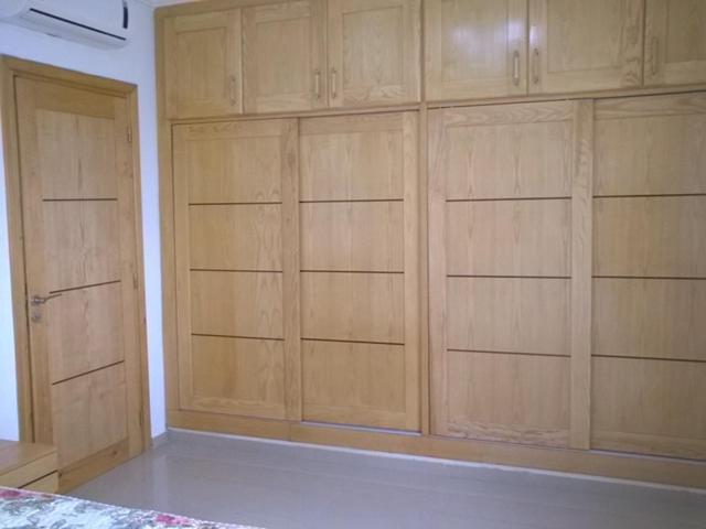 a room with wooden cabinets in a room at Appartement Les Rosiers in Hammam Sousse