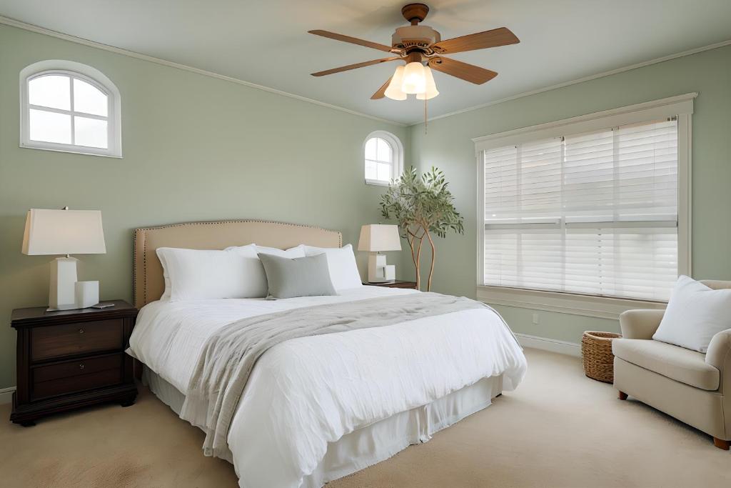 a bedroom with a white bed and a ceiling fan at Aspen Chic in Aspen
