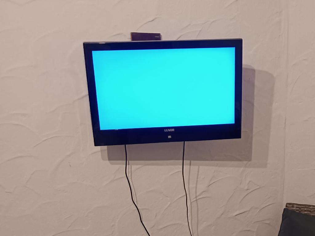 a television with a blue screen hanging on a wall at Haus Neckarblick in Haßmersheim