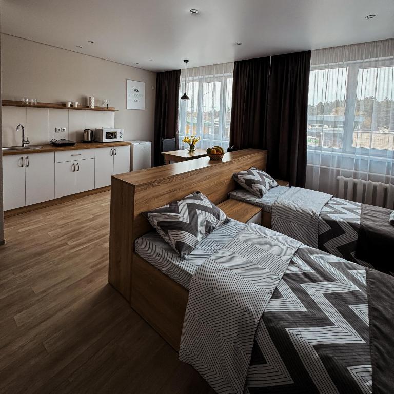 a large room with two beds and a kitchen at Поділля in Netishyn