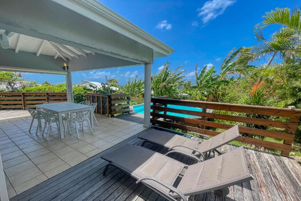 a patio with a table and chairs on a deck at GPSA82 - 4 pax in Fouché