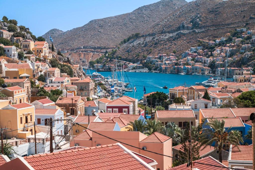 a view of a town with boats in the water at Oceanis apartment in Symi