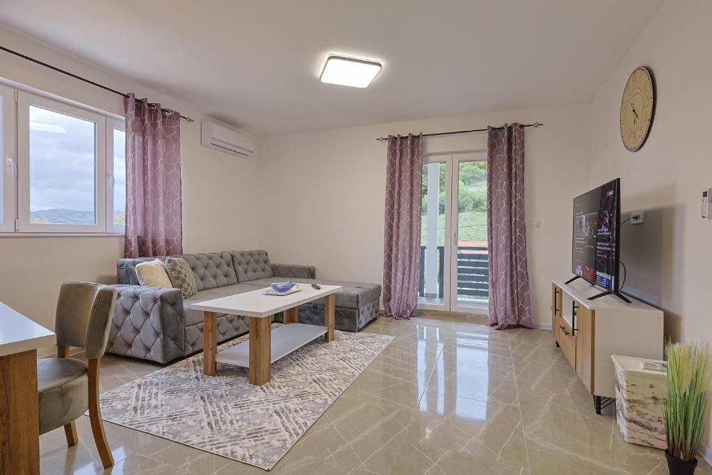 a living room with a couch and a table at NolE Apartments in Visoko