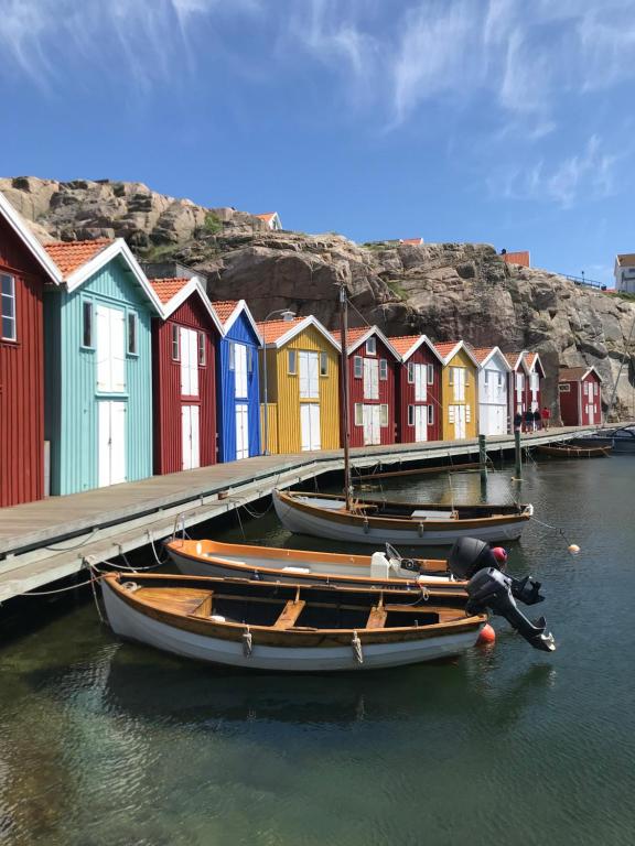 a row of colorful houses on the water with boats at Nyare lägenhet på Smögen, nära allt in Smögen
